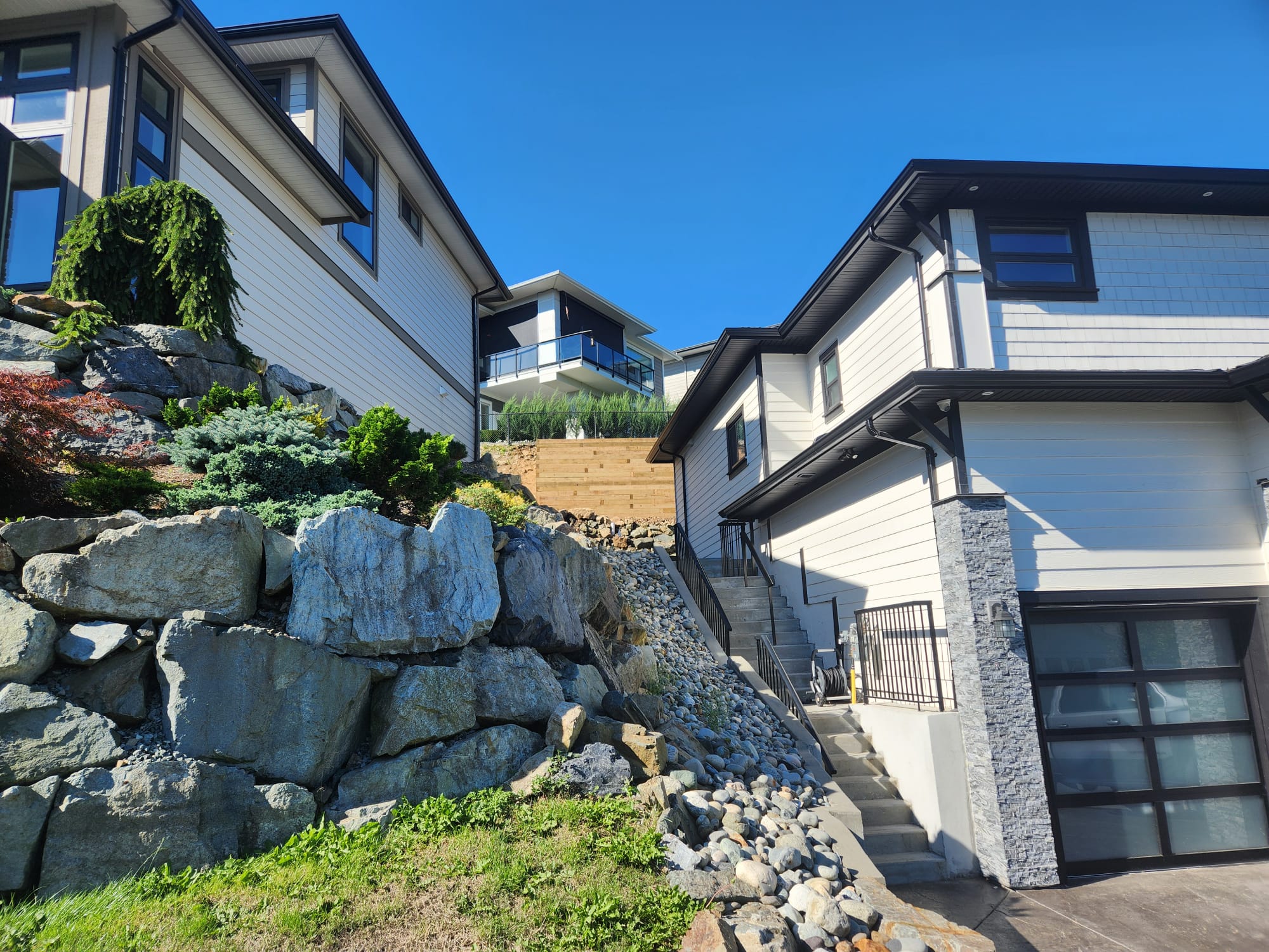 Natural stone retaining wall beside a Lower Mainland home
